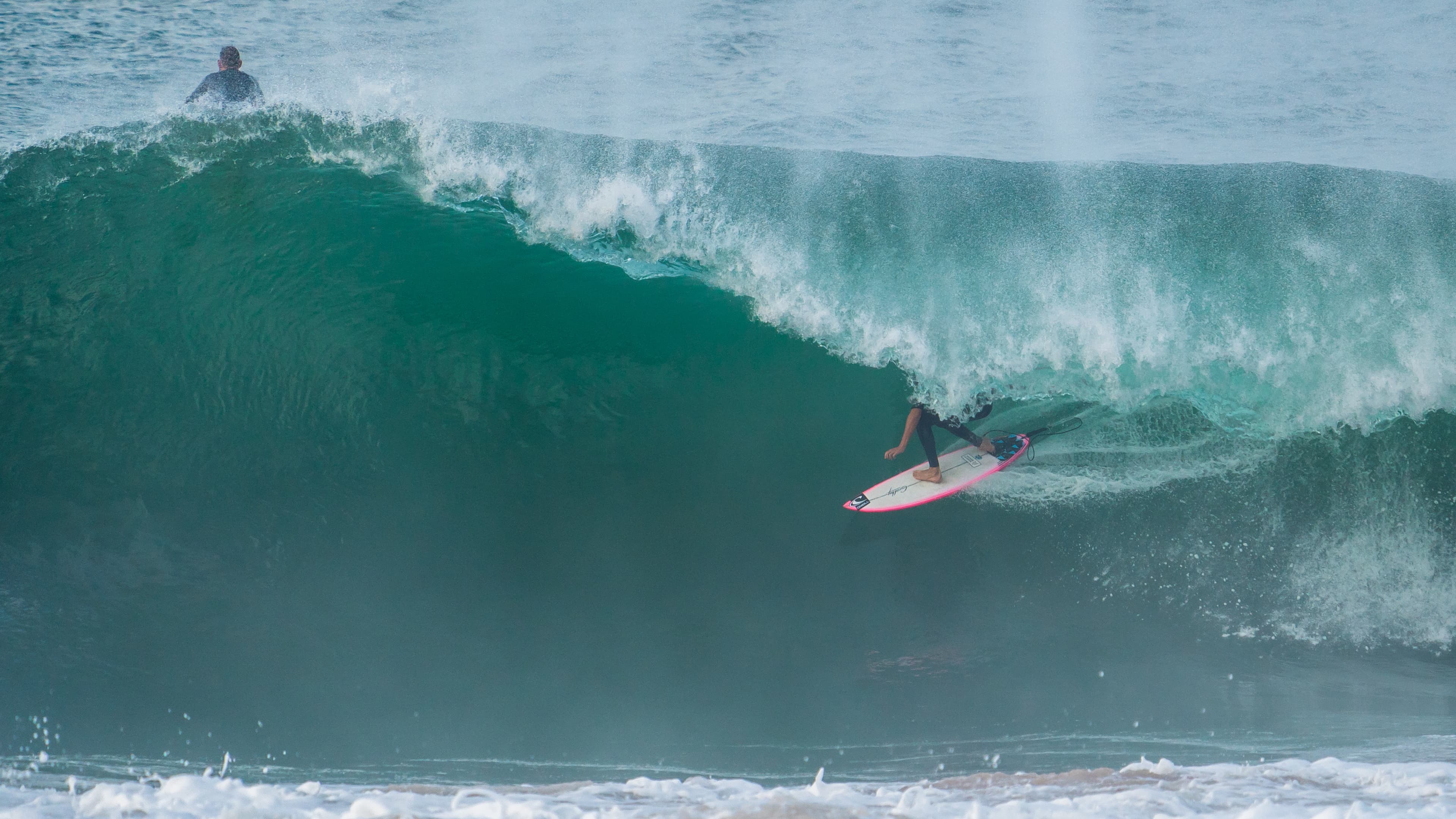 Nate Colby surfing inside a large barrel